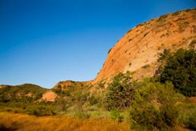 A cliff at Black Star Canyon against a blue sky.