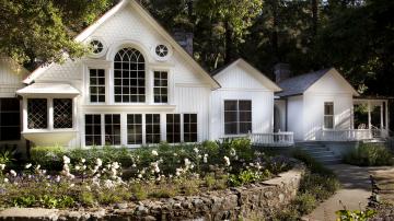 White 1800s home with large windows