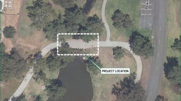 Aerial image of a path over a creek and a white box showing project area