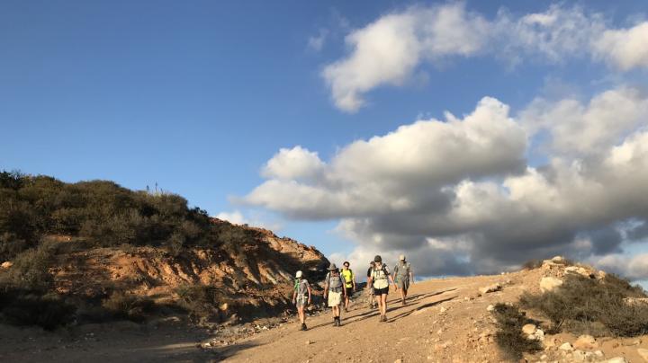 Hikers descend a trail in Fremont Canyon