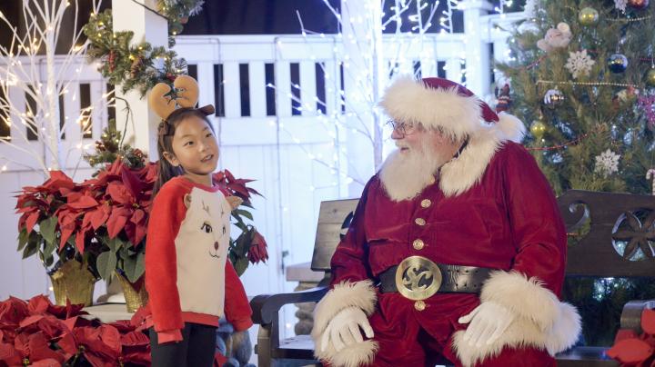 Santa with child at Candlelight Walk