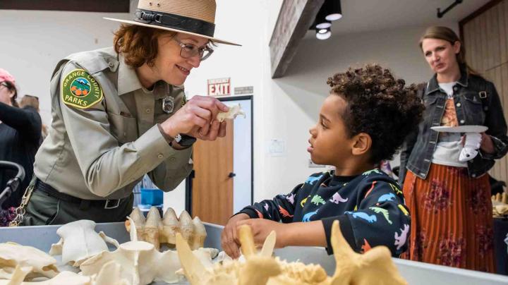 Resource specialist with fossils and child 