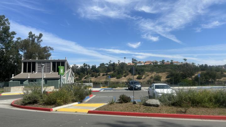 Boathouse next to parked cars in a parking lot. 