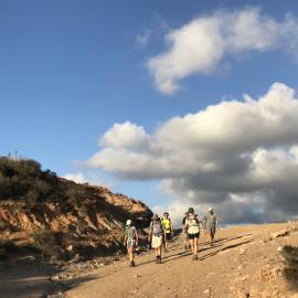 Hikers descend a trail in Fremont Canyon