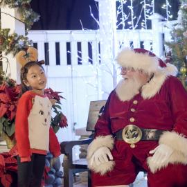 Santa with child at Candlelight Walk