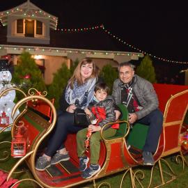 Family on a sleigh at Holiday Lights