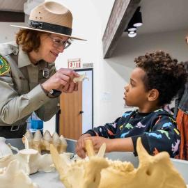 Resource specialist with fossils and child 