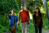 3 people hiking on a wooded trail