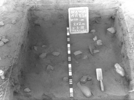 Old black and white photo of artifacts in a dig site
