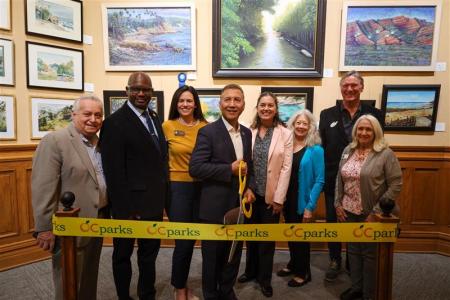Officials cut the ribbon to open Omnivision: Art Across Boundaries now on display at the Old Orange County Courthouse